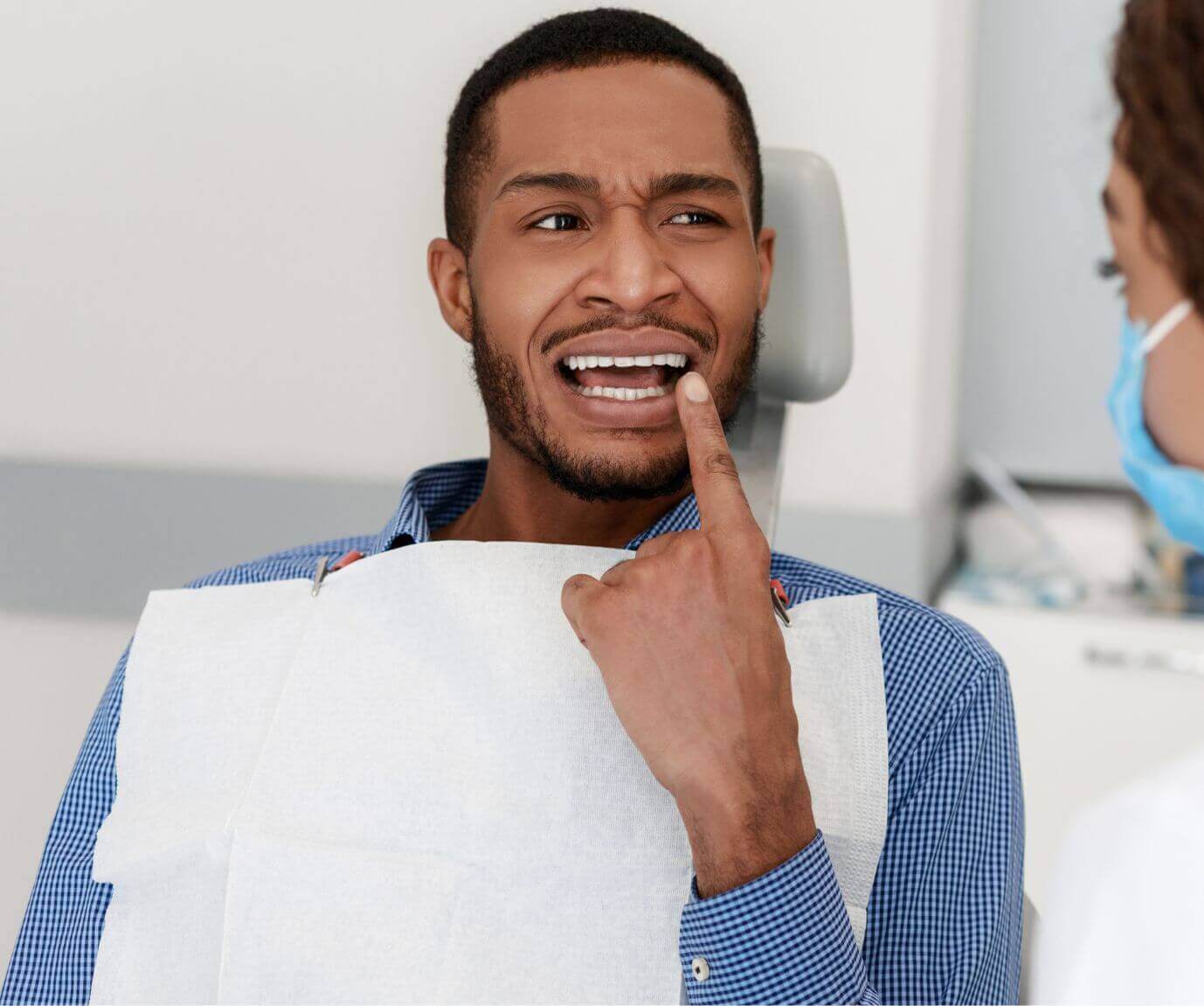 Man sat in dental practice with wisdom tooth pain